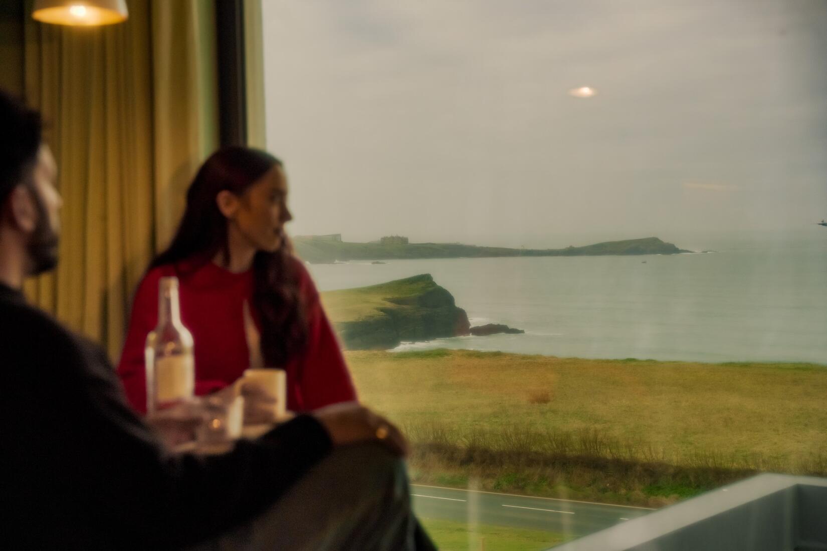People sat by the window in a sea view studio at SeaSpace