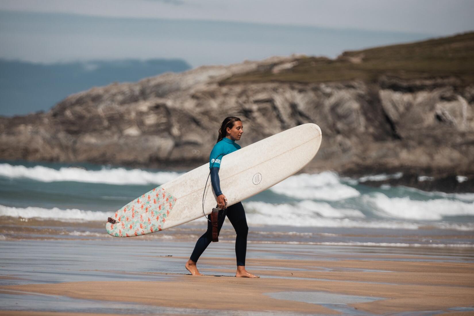 Surfer leaving the water at Fistral