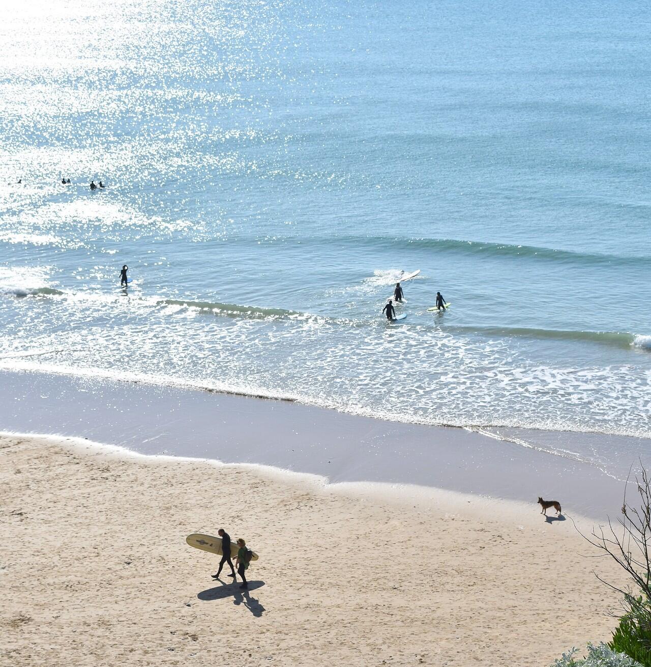 Surfers in the water at Watergate Bay taken from the coaat path