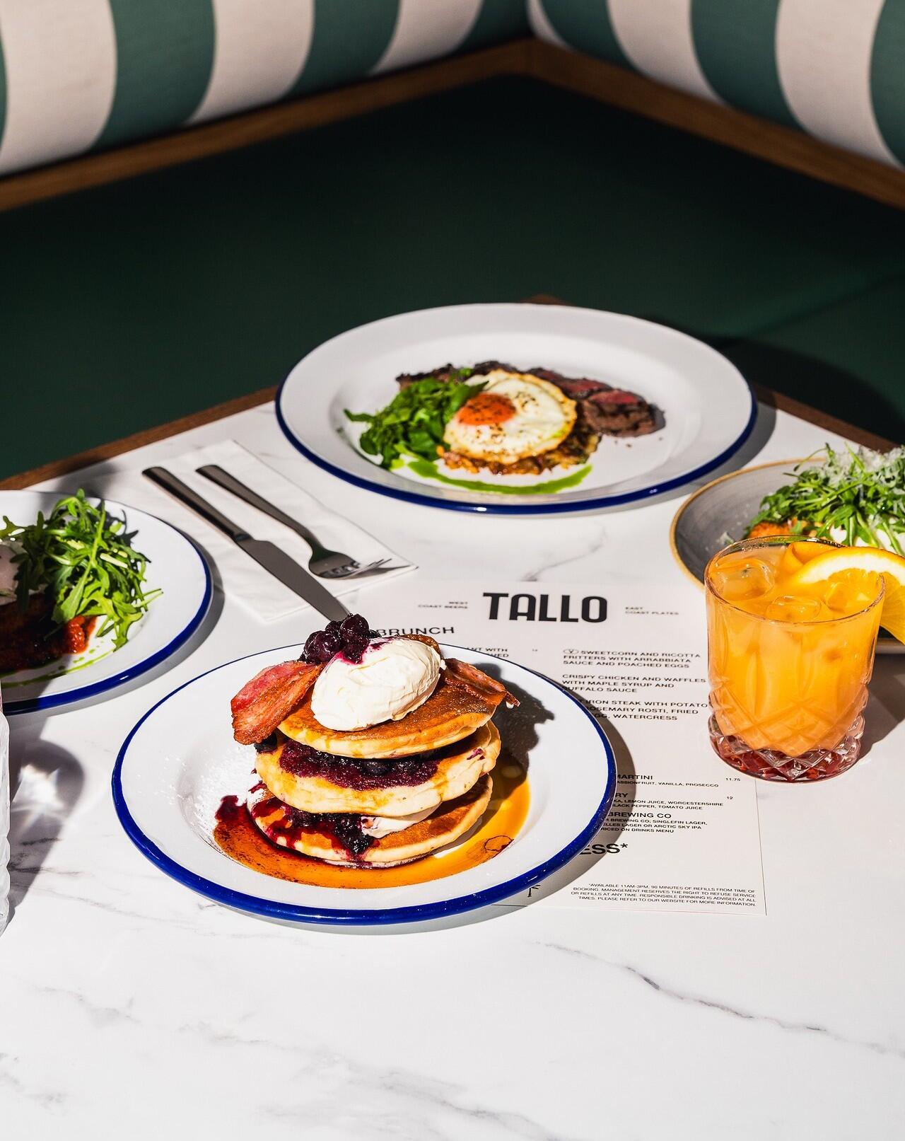 Flat iron steak dish, bacon and berry pancakes, multiple plates for TALLO brunch