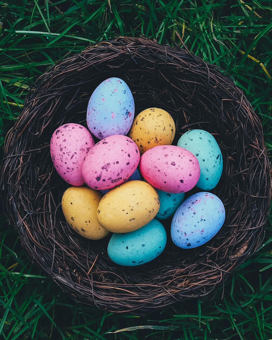 Wicker basket of colourful Easter eggs