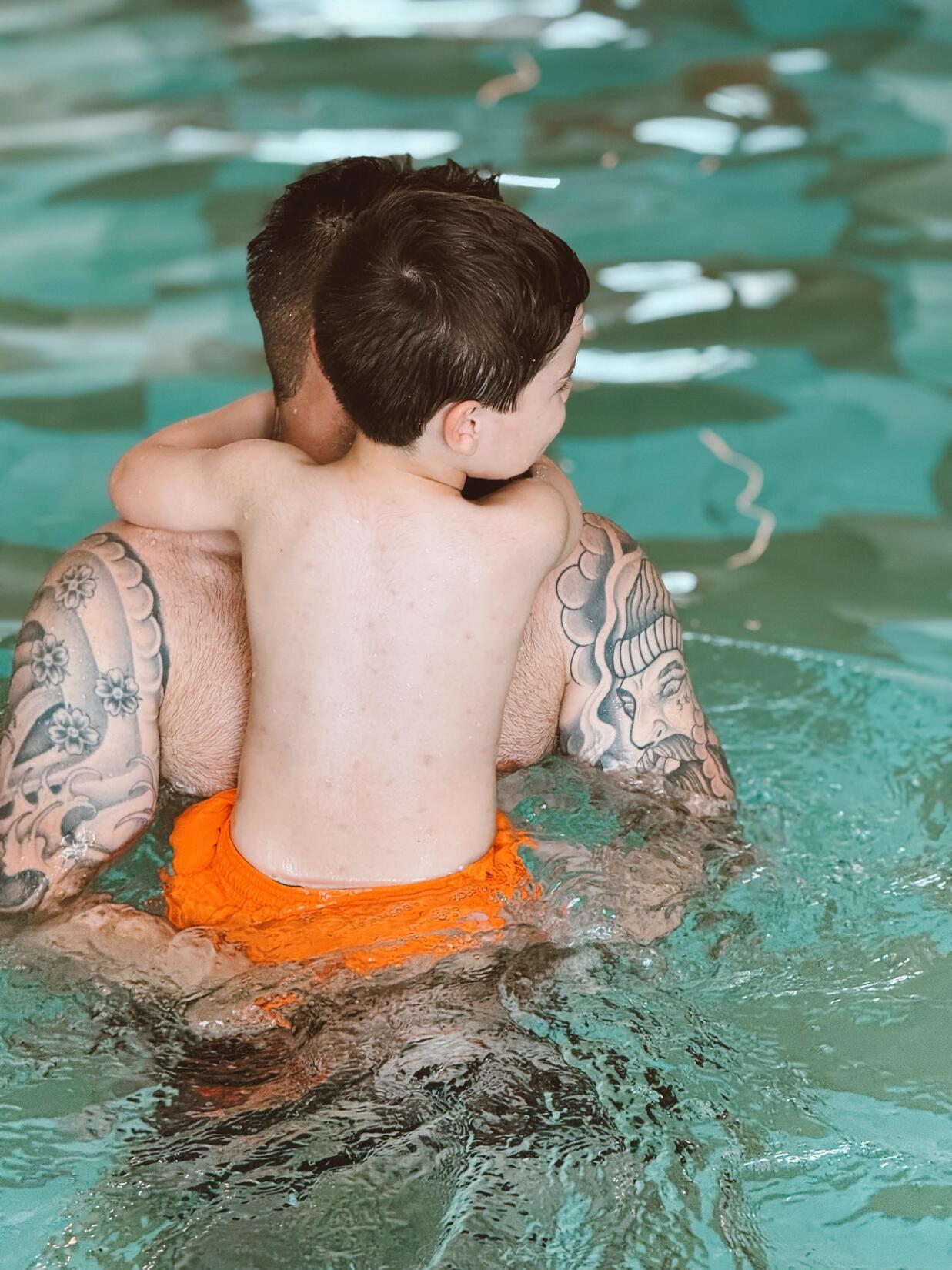 Father and son swimming in the SeaSpace pool