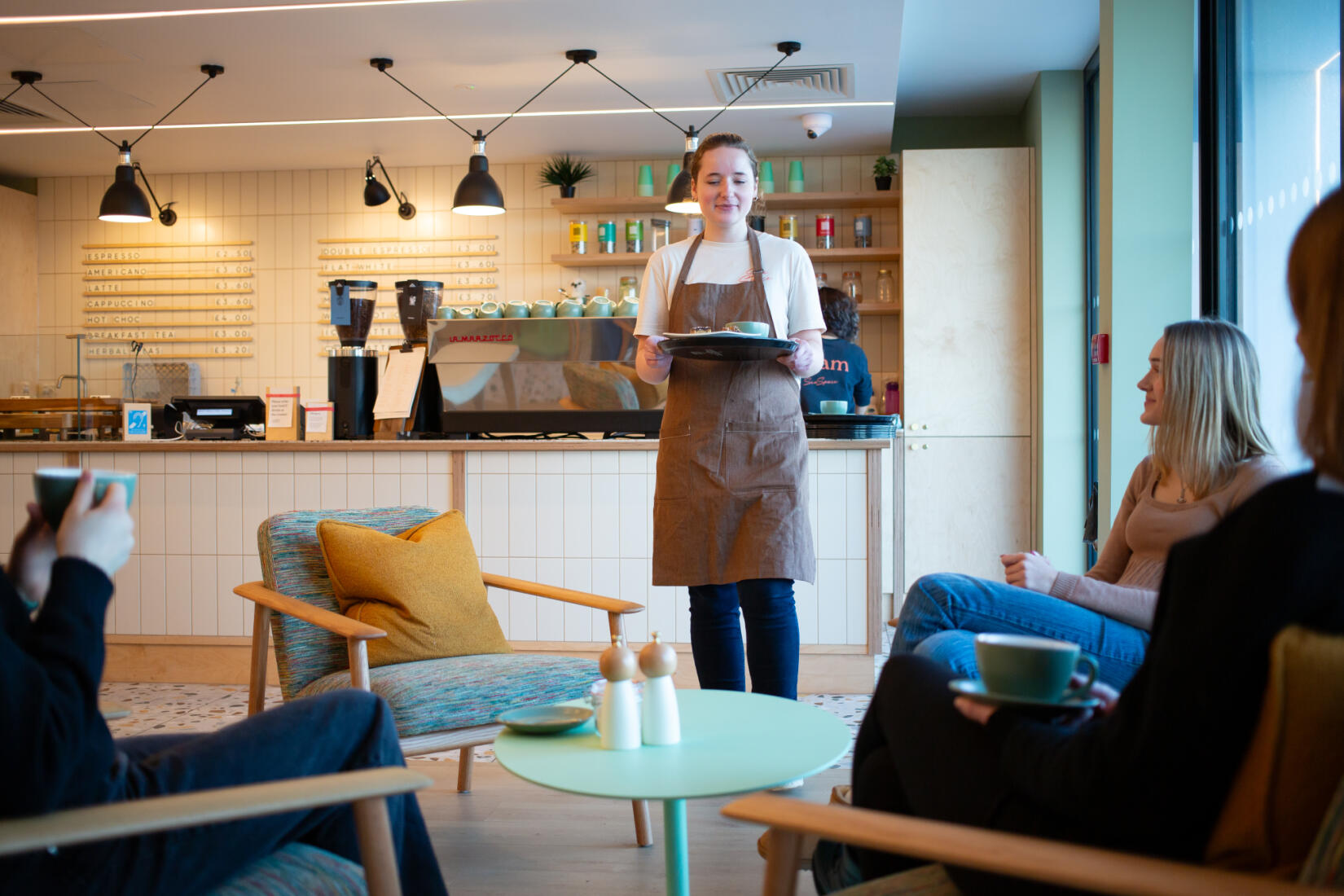 Girl serving coffee in the cafe at SeaSpace