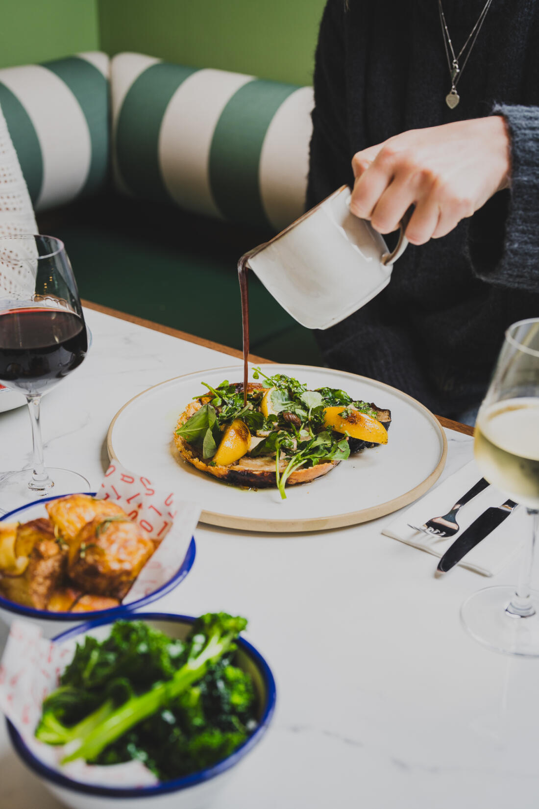 Person pouring gravy onto a roast at TALLO at SeaSpace