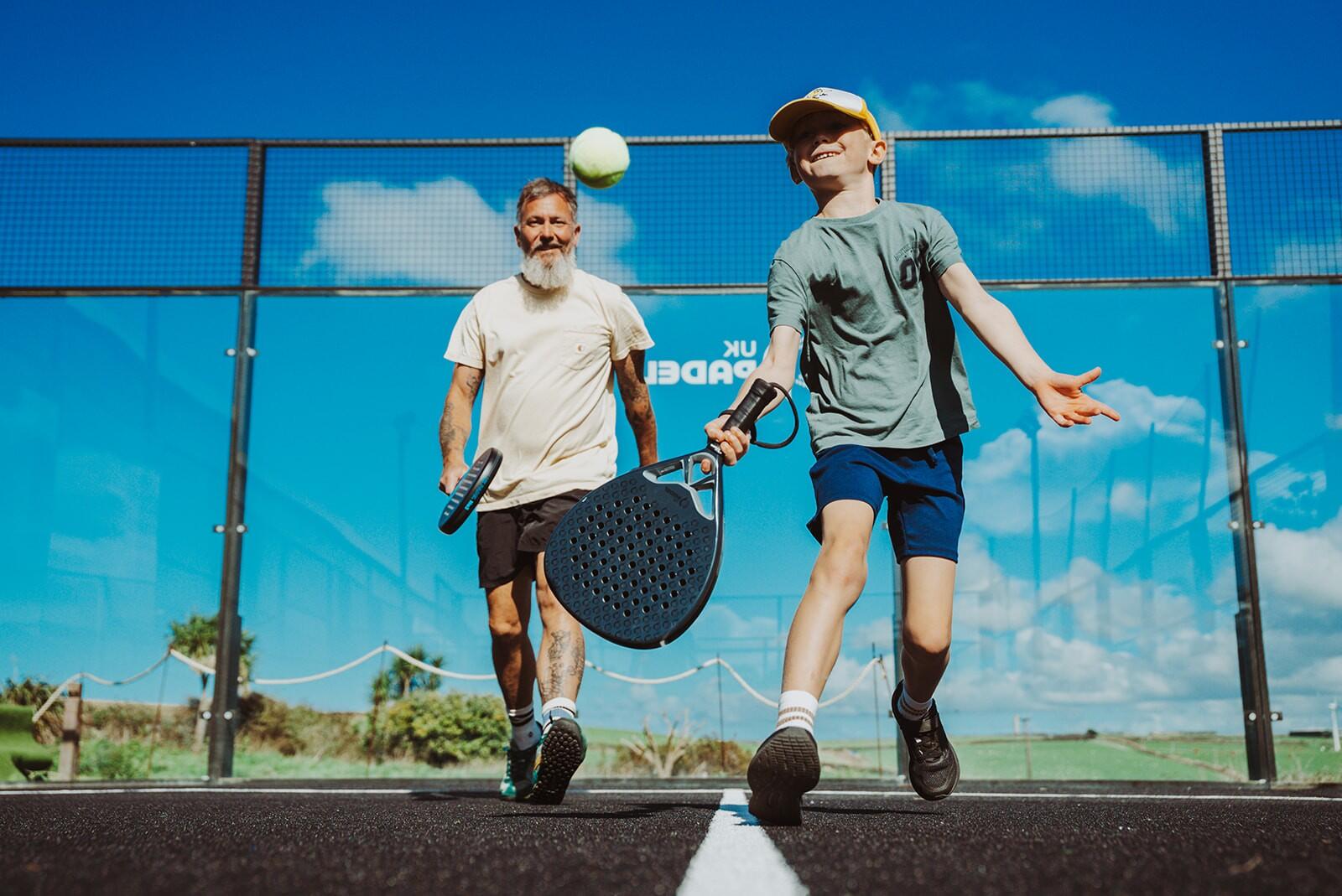 Man and his son playing padel at SeaSpace