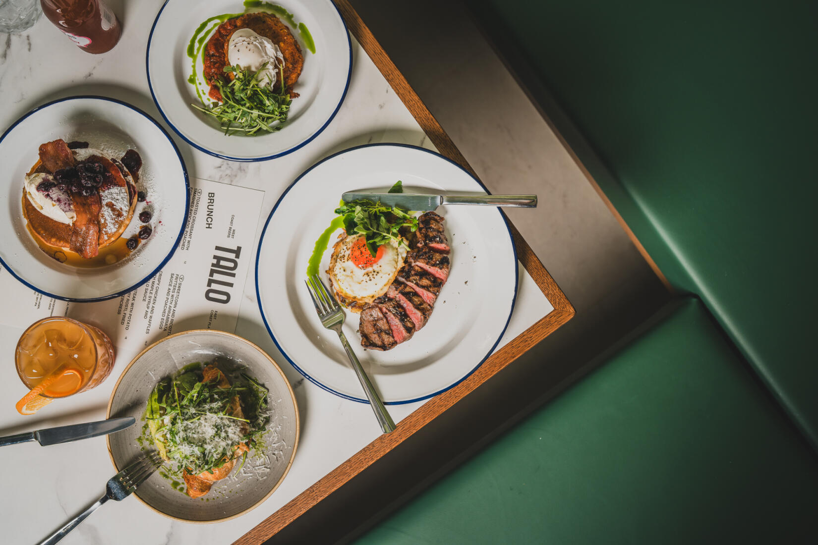 Photo of brunch at Tallo shot from above including pancakes, sweetcorn fritters, eggs