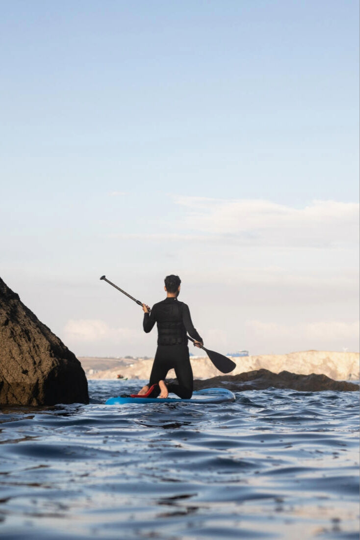Man paddleboarding towards Newquay